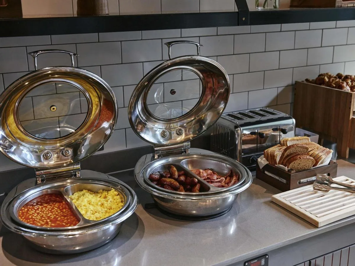 three bowls of food on a counter in a kitchen at Aparthotel Adagio Glasgow Central in Glasgow
