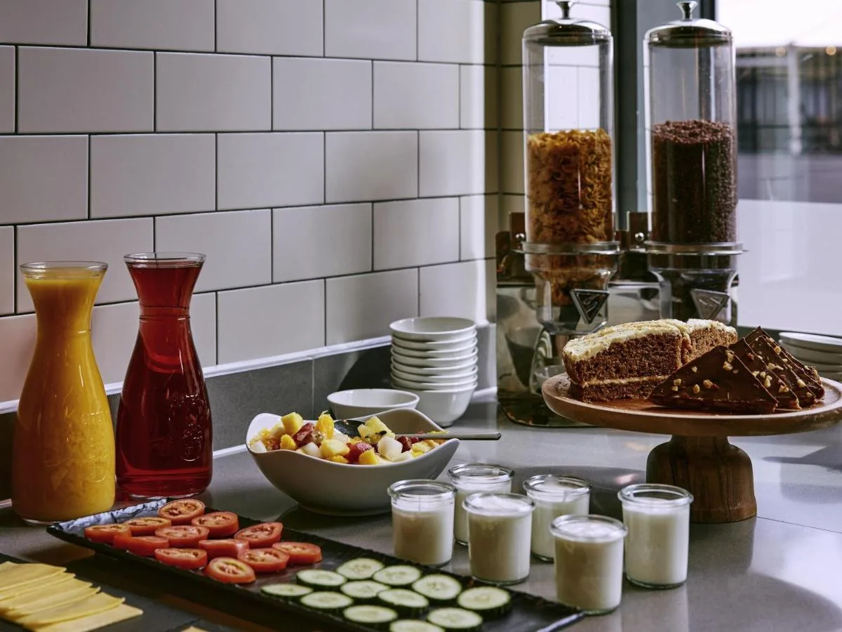 a counter with food and a plate of food at Aparthotel Adagio Glasgow Central in Glasgow